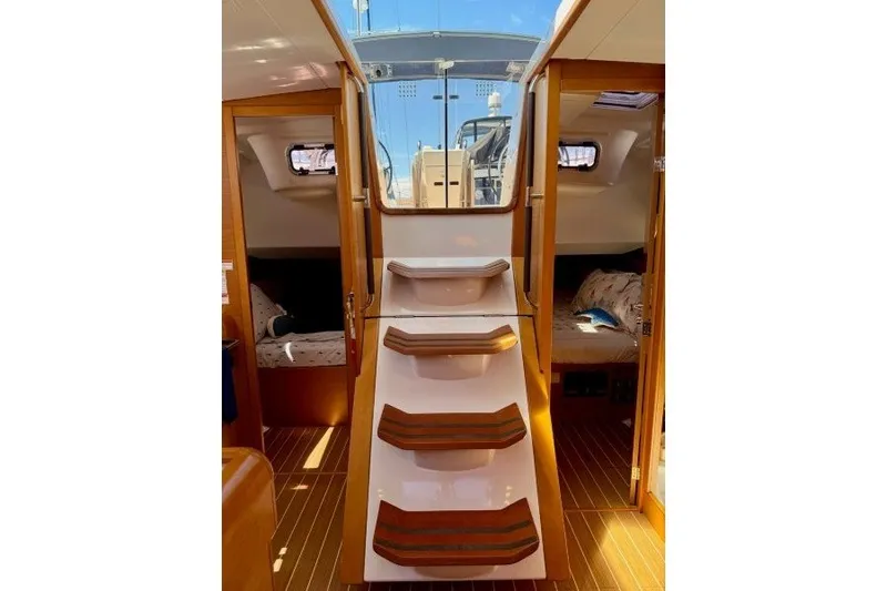 Slide: The Image of Interior view of 2013 Jeanneau Sun Odyssey 469 sailboat with wooden steps and cozy cabins. - 18