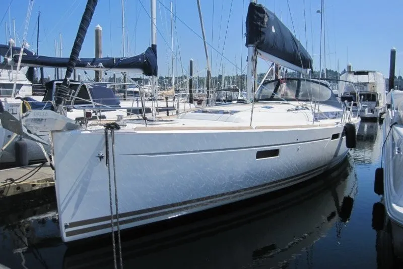 Slide: The Image of 2013 Jeanneau Sun Odyssey 469 sailboat docked in a marina. - 46