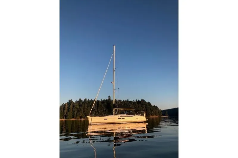 Slide: The Image of 2013 Jeanneau Sun Odyssey 469 sailboat on calm water at sunset. - 49