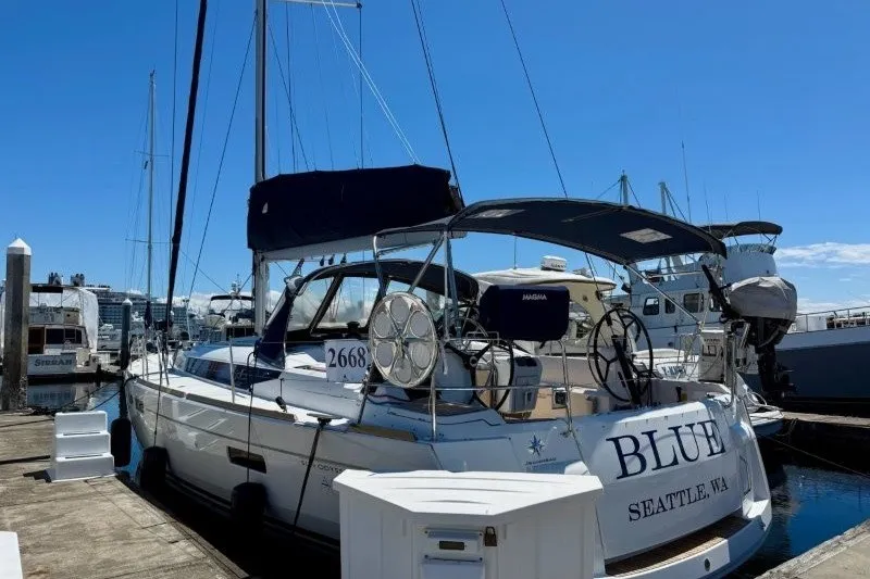 Slide: The Image of 2013 Jeanneau Sun Odyssey 469 sailboat docked in Seattle marina under clear blue sky. - 54