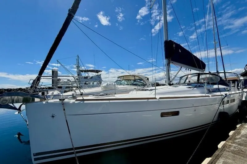 Slide: The Image of 2013 Jeanneau Sun Odyssey 469 sailboat docked under a clear blue sky. - 57