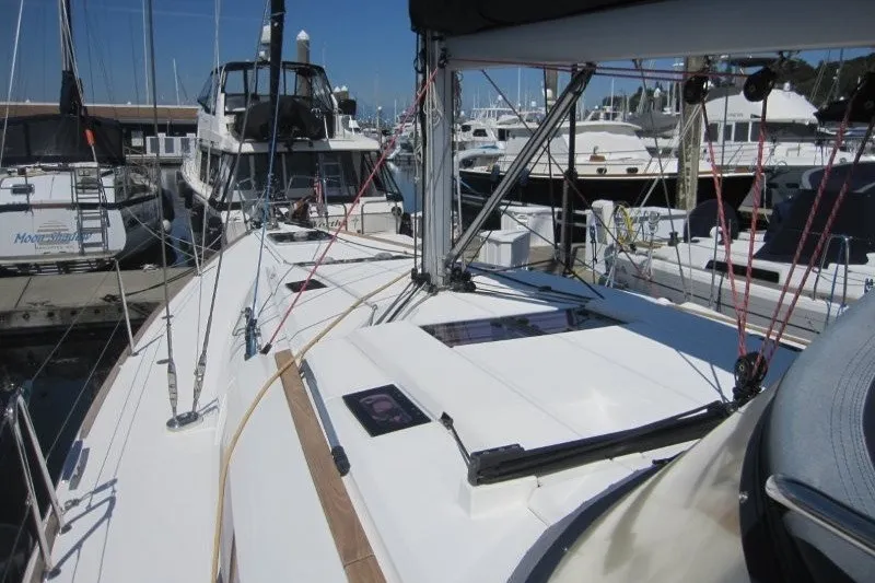 Slide: The Image of 2013 Jeanneau Sun Odyssey 469 sailboat docked at a marina, surrounded by other boats. - 42