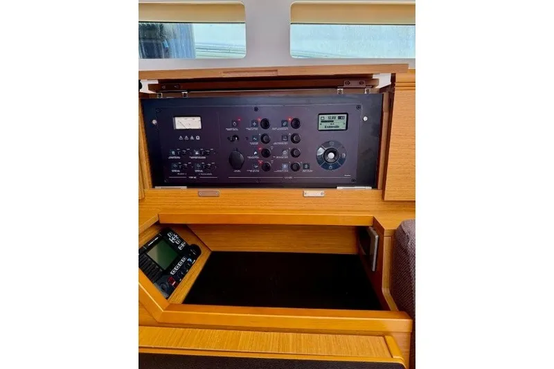 Slide: The Image of Control panel of a 2013 Jeanneau Sun Odyssey 469 sailboat, featuring navigation and electrical systems. - 15
