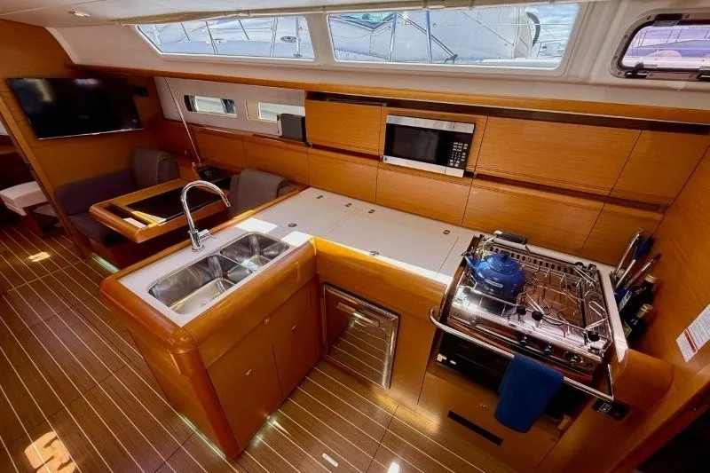 Slide: The Image of Interior of 2013 Jeanneau Sun Odyssey 469 yacht with modern kitchen and seating area. - 19