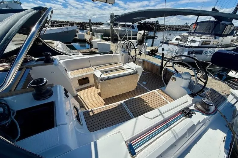Slide: The Image of 2013 Jeanneau Sun Odyssey 469 sailboat cockpit with dual steering wheels at marina. - 52