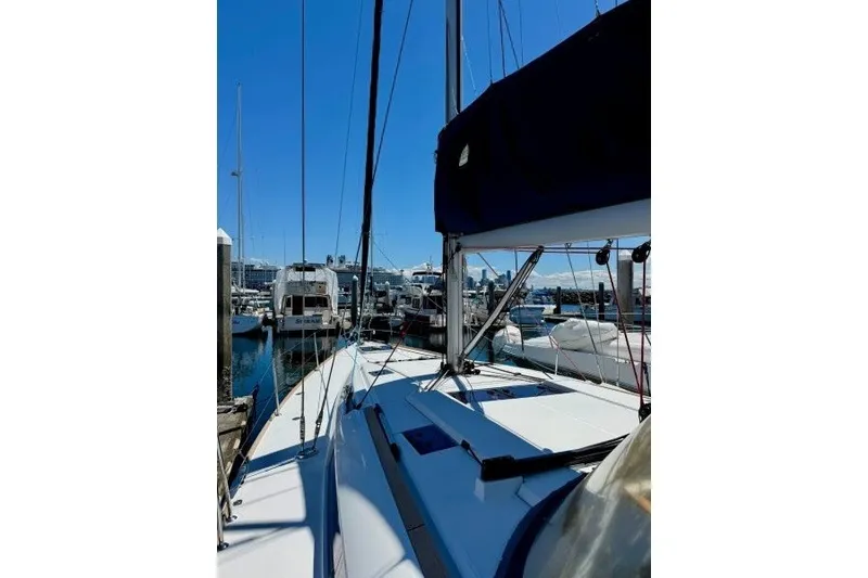 Slide: The Image of 2013 Jeanneau Sun Odyssey 469 sailboat docked in a marina under clear blue skies. - 53