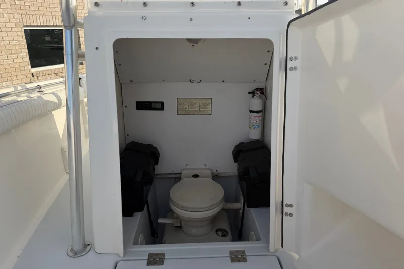 Slide: The Image of 2002 Silverhawk 240 Center Console boat interior with toilet and fire extinguisher. - 27