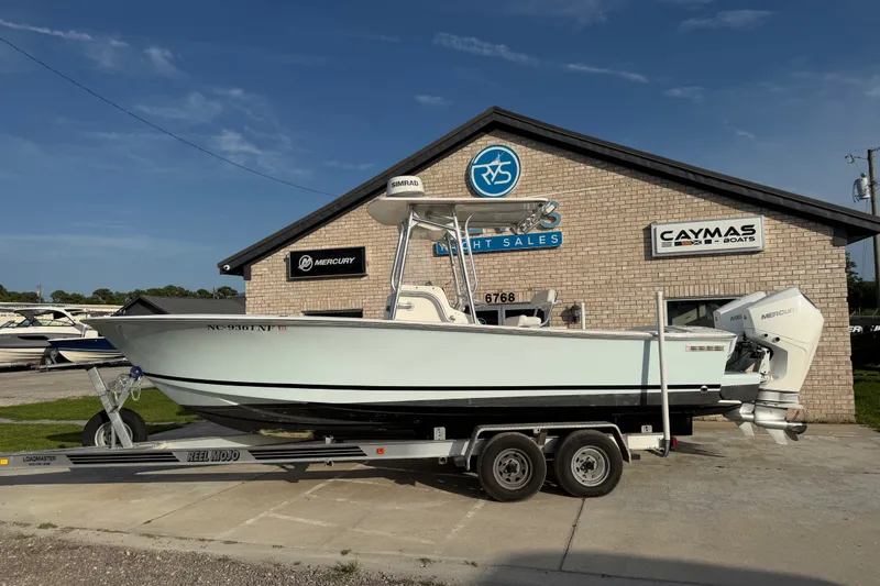 The Image of 2002 Silverhawk 240 Center Console boat on trailer outside yacht sales building. - 0