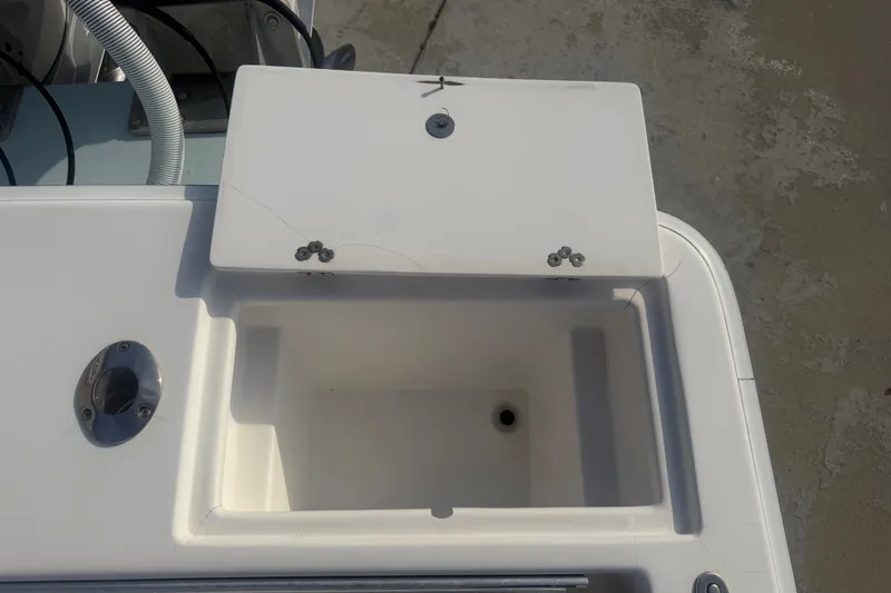 Slide: The Image of Open storage compartment on a 2002 Silverhawk 240 Center Console boat. - 22