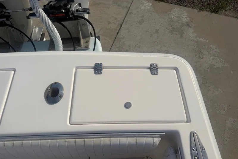 Slide: The Image of 2002 Silverhawk 240 Center Console boat deck with storage compartment and rod holder. - 21