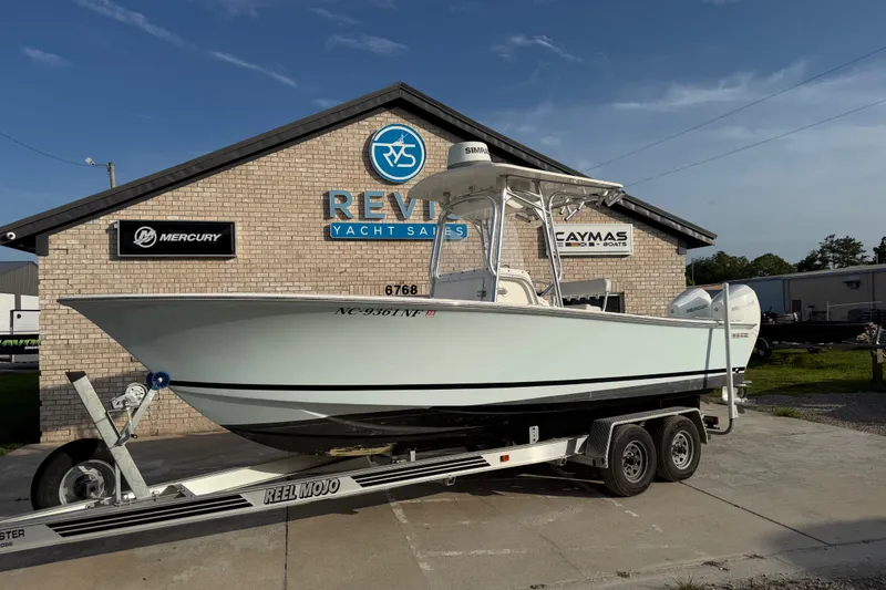 Slide: The Image of 2002 Silverhawk 240 Center Console boat on trailer at yacht sales dealership. - 2