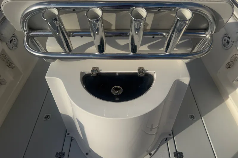 Slide: The Image of 2002 Silverhawk 240 Center Console boat with rod holders and storage compartment. - 13