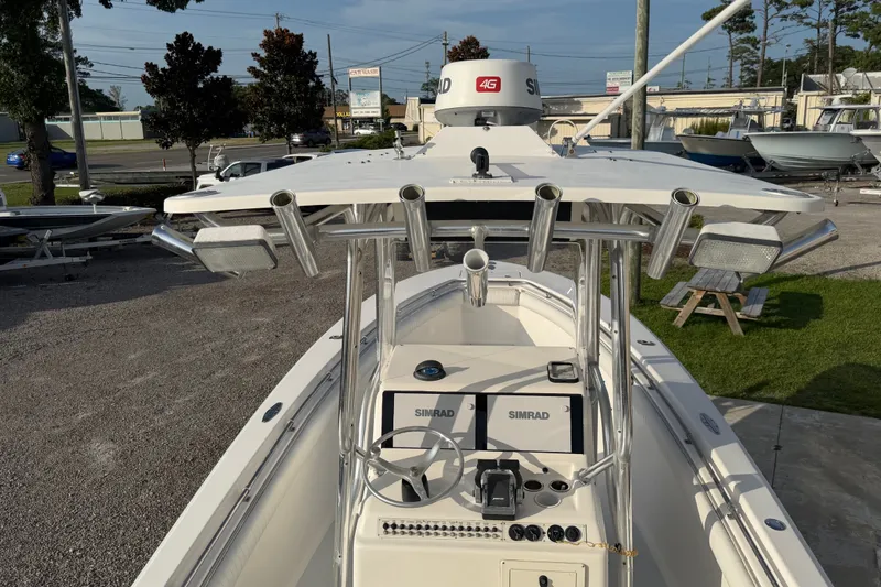 Slide: The Image of 2002 Silverhawk 240 Center Console boat with Simrad electronics, docked outdoors. - 11