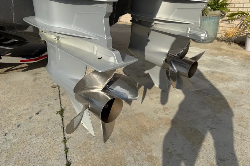 Slide: The Image of Twin propellers of a 2002 Silverhawk 240 Center Console boat on concrete surface. - 8