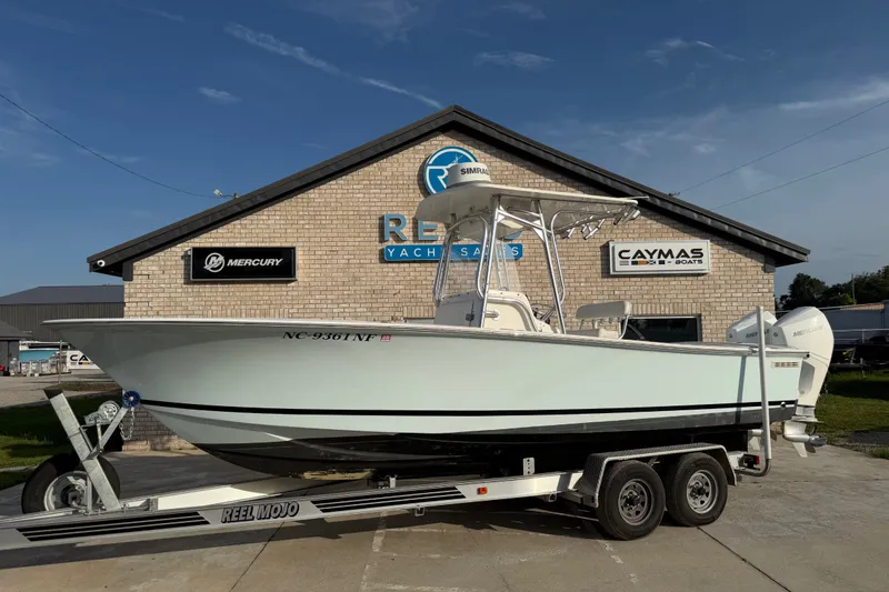 Slide: The Image of 2002 Silverhawk 240 Center Console boat on trailer at dealership, featuring Mercury engines. - 3