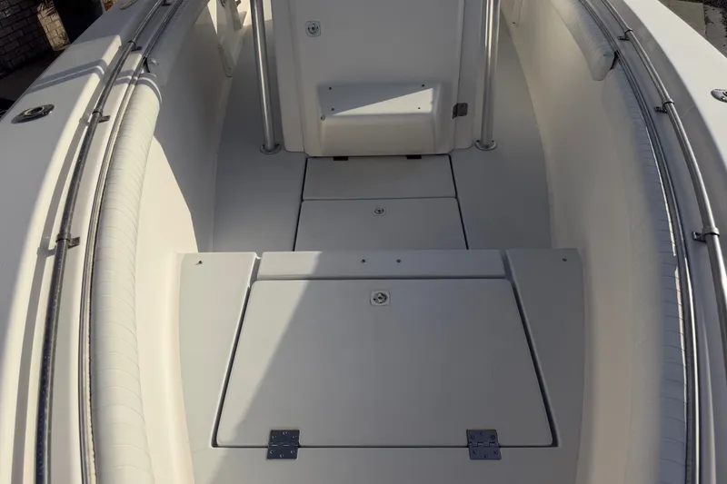 Slide: The Image of 2002 Silverhawk 240 Center Console boat interior with storage compartments and seating. - 25