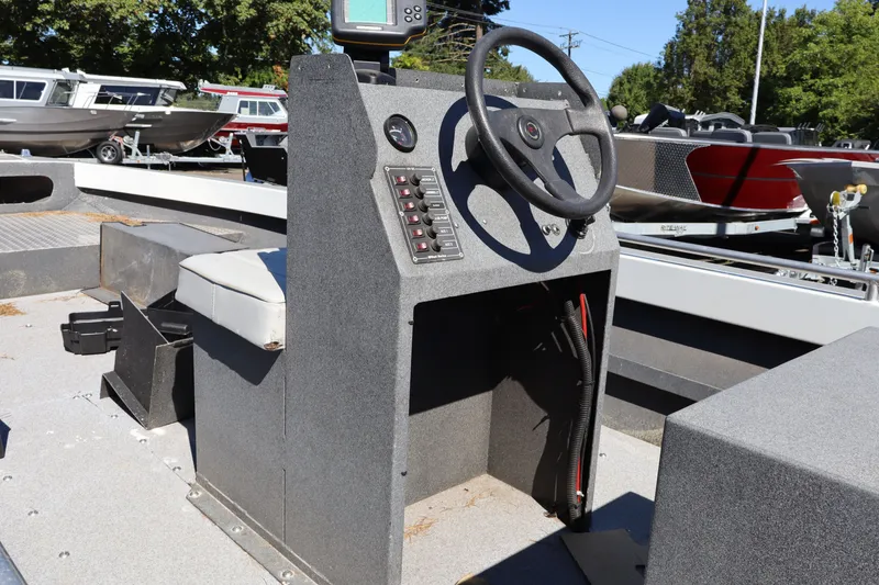 Slide: The Image of 2007 Tacoma Jet 17' Mechanic's Special boat interior with steering console and control panel. - 12
