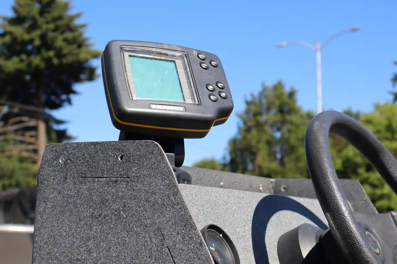 Slide: The Image of Fishfinder on a 2007 Tacoma Jet 17' Mechanic's Special boat dashboard, sunny day. - 10