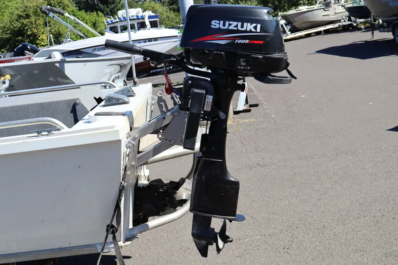 Slide: The Image of Outboard motor on a 2007 Tacoma Jet 17' Mechanic's Special boat, parked outdoors. - 7