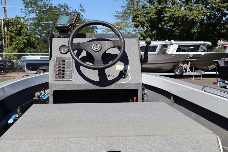 Slide: The Image of 2007 Tacoma Jet 17' boat dashboard with steering wheel and control panel. - 9