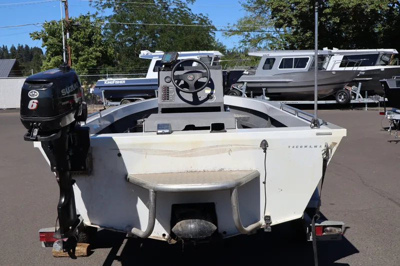 Slide: The Image of 2007 Tacoma Jet 17' boat with Suzuki outboard motor, parked on trailer. - 6