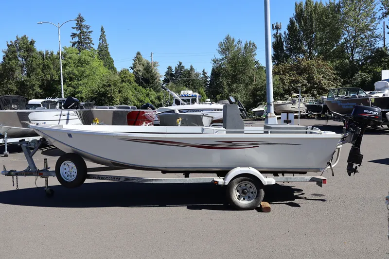 Slide: The Image of 2007 Tacoma Jet 17' Mechanic's Special boat on trailer, parked outdoors. - 2