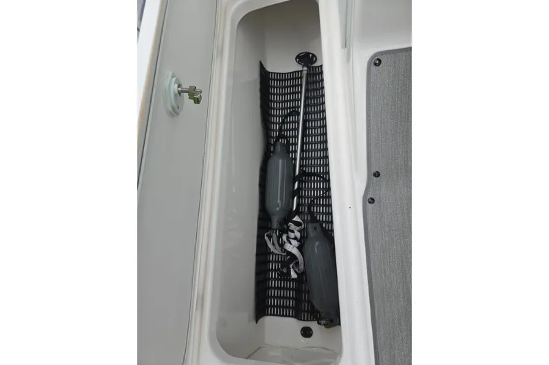 Slide: The Image of Storage compartment in 2023 Yamaha Boats AR195, featuring organized boat accessories. - 15