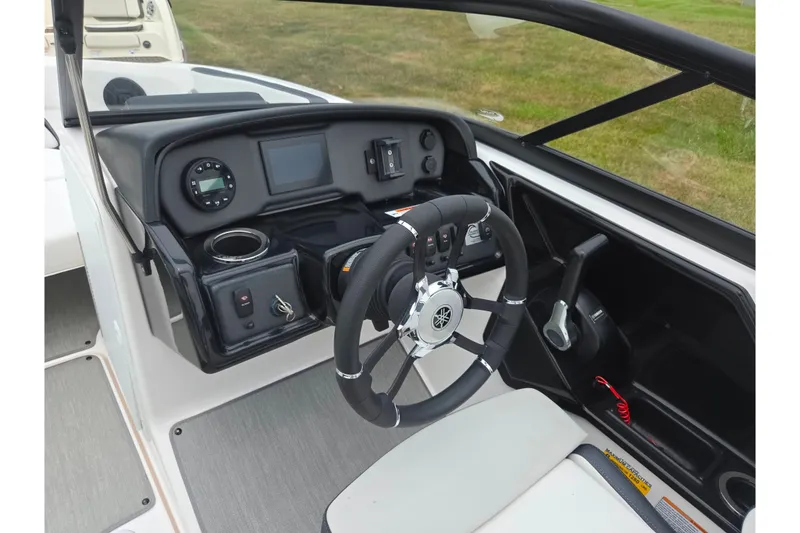 Slide: The Image of 2023 Yamaha AR195 boat dashboard with steering wheel and control panel. - 13