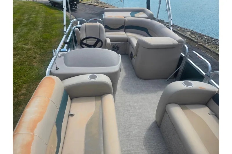 Slide: The Image of Interior of a 2012 Avalon A Fish 16' pontoon boat with beige seating. - 11