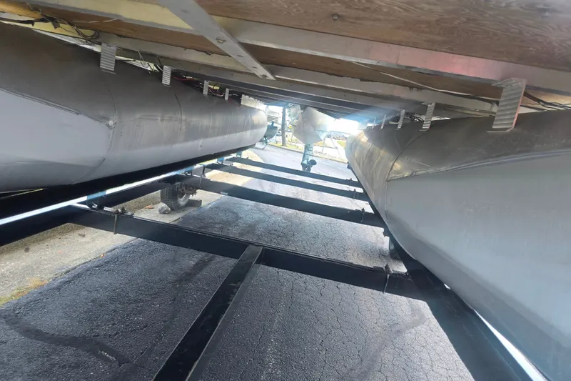 Slide: The Image of Underneath view of a 2012 Avalon A Fish 16' pontoon boat on a trailer. - 7