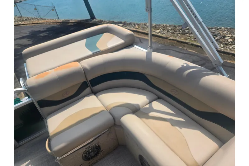 Slide: The Image of Interior seating of a 2012 Avalon A Fish 16' boat by the water. - 14