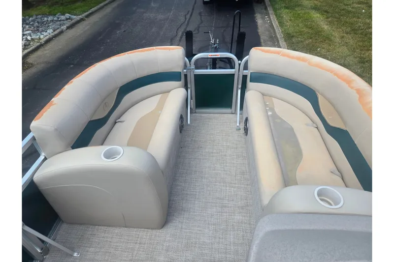 Slide: The Image of 2012 Avalon A Fish 16' boat interior with beige seating and cup holders. - 21
