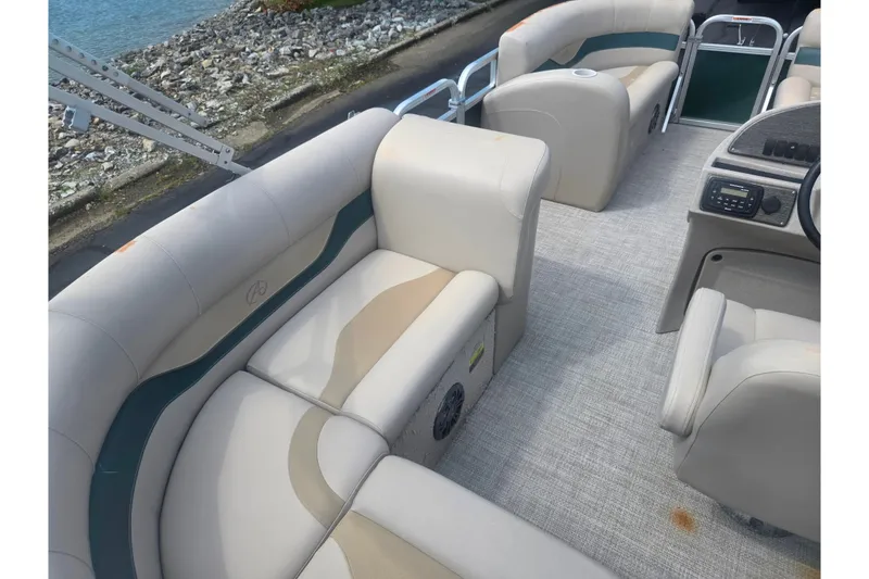 Slide: The Image of Interior of a 2012 Avalon A Fish 16' boat with beige seating and console. - 17