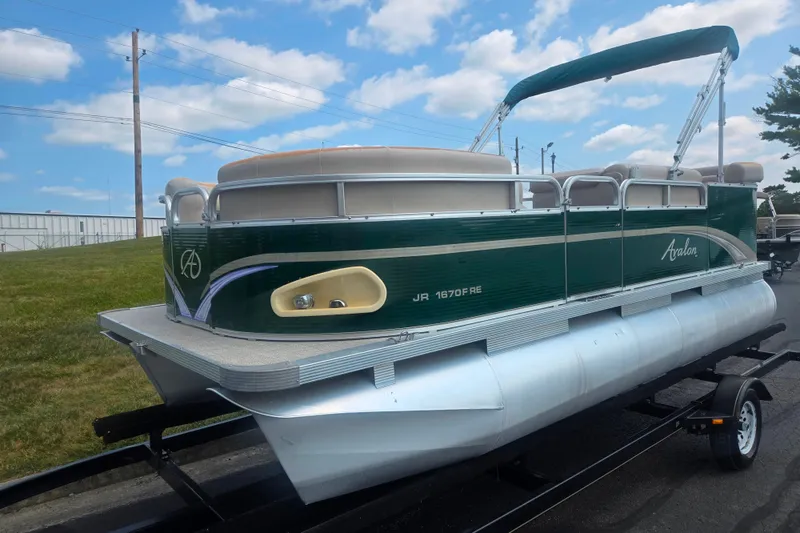 Slide: The Image of 2012 Avalon A Fish 16' pontoon boat on trailer under blue sky. - 5