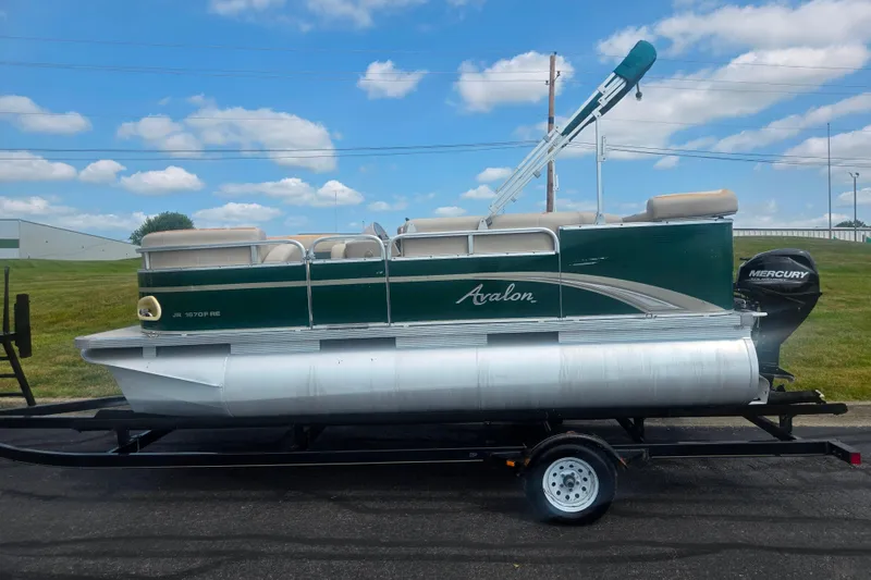 Slide: The Image of 2012 Avalon A Fish 16' pontoon boat on trailer, green and silver design, Mercury engine. - 4