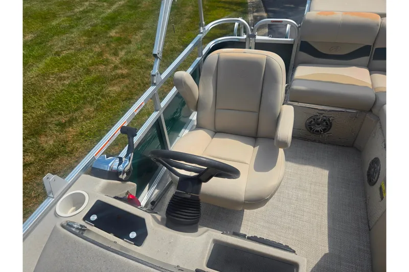 Slide: The Image of Interior of a 2012 Avalon A Fish 16' boat with beige seating and steering wheel. - 13