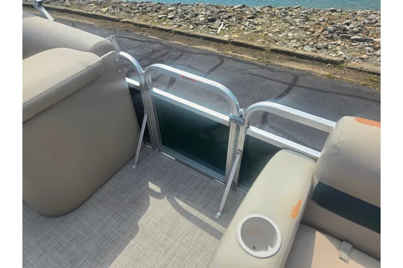 Slide: The Image of Interior view of a 2012 Avalon A Fish 16' boat with beige seating and railing. - 12