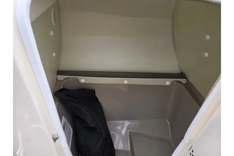 Slide: The Image of Storage compartment of 2014 Yamaha Boats 242 Limited S, featuring spacious interior and black cover. - 15