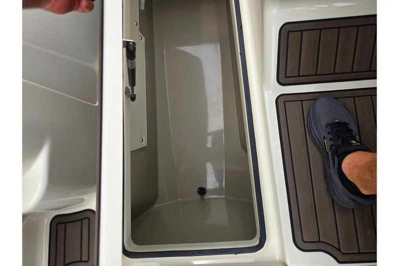 Slide: The Image of Open storage compartment on 2014 Yamaha Boats 242 Limited S, with non-slip flooring visible. - 16