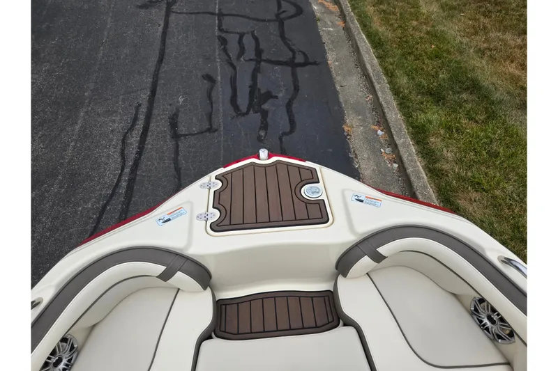 Slide: The Image of Bow view of 2014 Yamaha Boats 242 Limited S with cushioned seating and wood accents. - 18