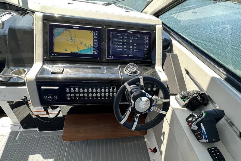 Slide: The Image of Helm of 2026 Cruisers Yachts 42 GLS OB with dual Simrad displays and modern controls. - 15