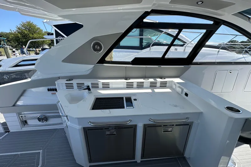Slide: The Image of 2026 Cruisers Yachts 42 GLS OB interior with sleek kitchen and modern design. - 12