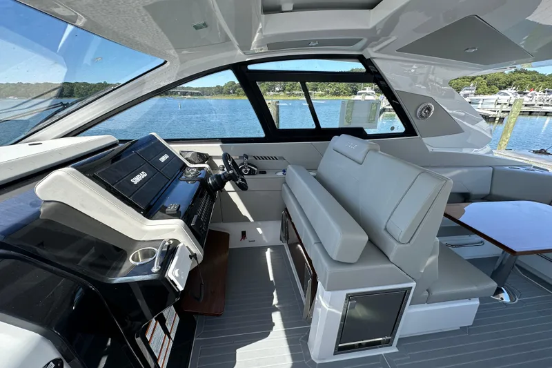 Slide: The Image of 2026 Cruisers Yachts 42 GLS OB interior with helm, seating, and water view. - 13
