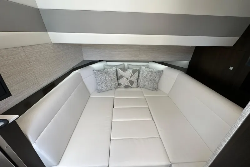 Slide: The Image of Luxurious interior of 2026 Cruisers Yachts 42 GLS OB with plush seating and decorative pillows. - 17