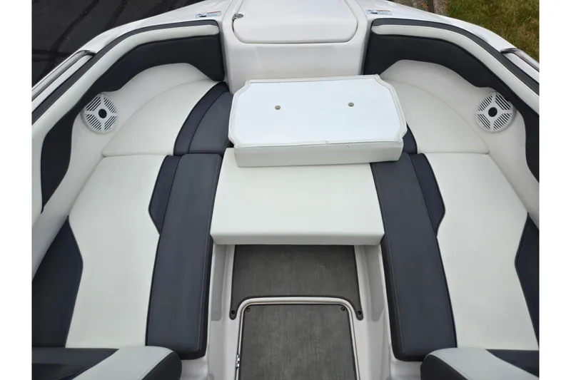 Slide: The Image of 2022 Yamaha Boats AR210 interior with cushioned seating and speakers. - 16