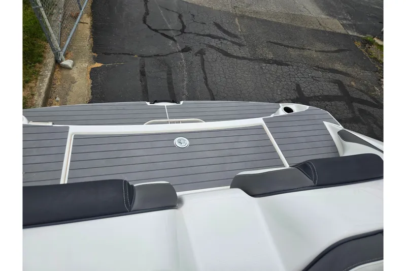 Slide: The Image of 2022 Yamaha Boats AR210 swim platform with gray decking and black seating. - 23