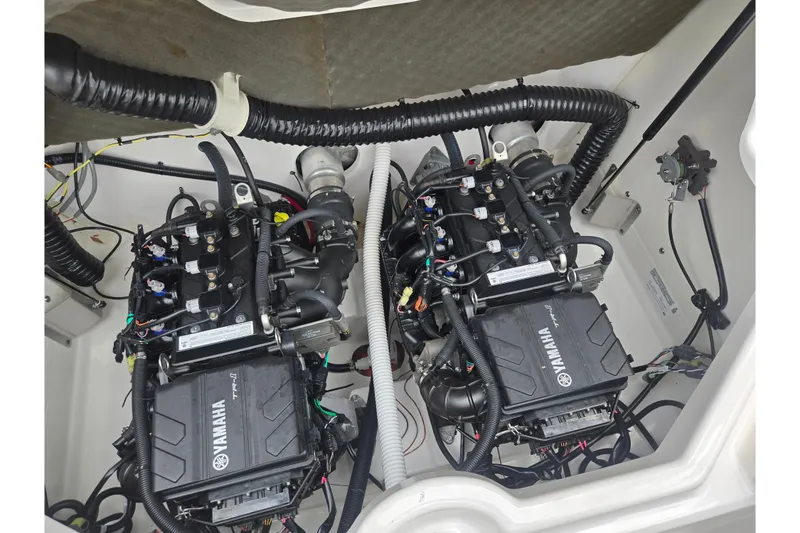 Slide: The Image of 2022 Yamaha AR210 boat engine compartment with dual engines and wiring. - 22