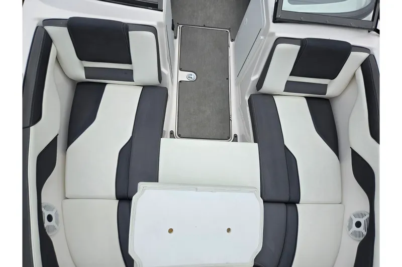 Slide: The Image of 2022 Yamaha Boats AR210 interior seating with sleek black and white upholstery design. - 18