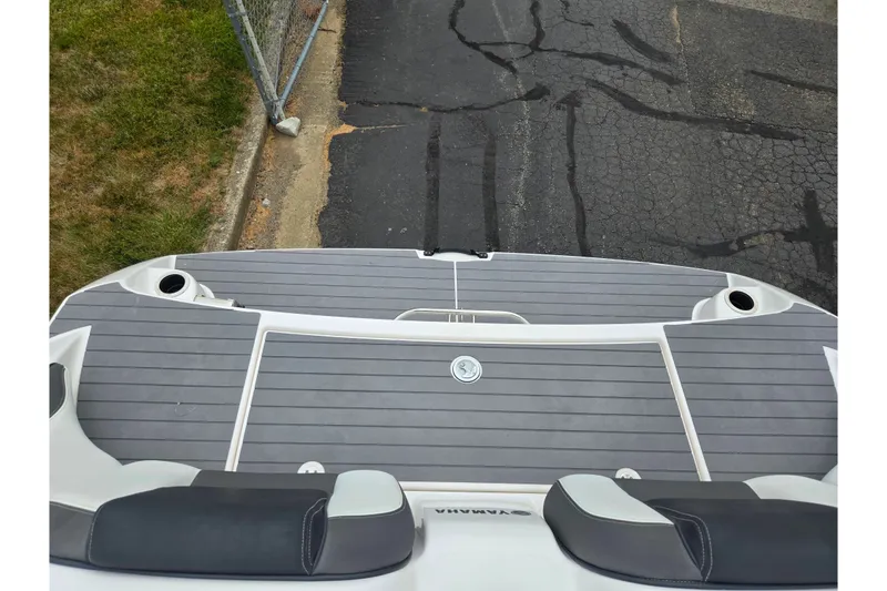 Slide: The Image of 2022 Yamaha Boats AR210 swim platform with gray decking and cup holders. - 24