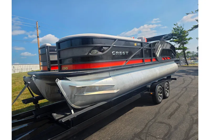 Slide: The Image of 2023 Crest Caribbean RS 230 pontoon boat on trailer under blue sky. - 5